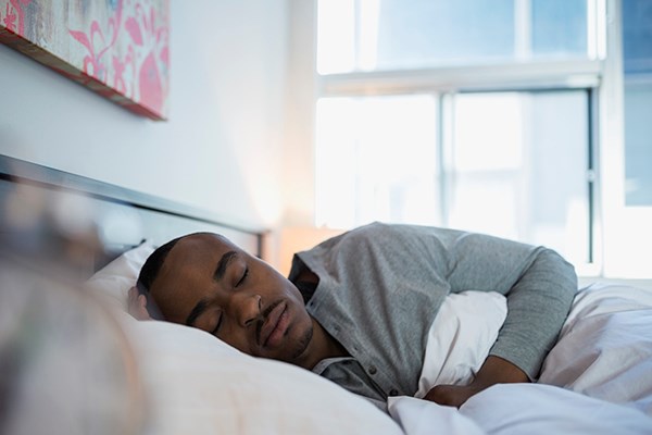 Man sleeps in a bed